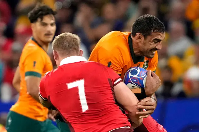 Australia's lock Richie Arnold is tackled by Wales' openside flanker and captain Jac Morgan