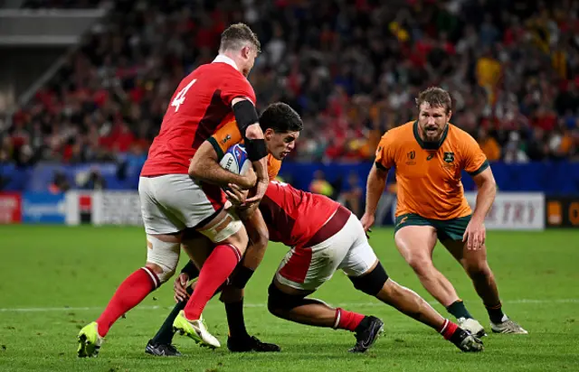 Ben Donaldson of Australia is tackled by Will Rowlands and Taulupe Faletau