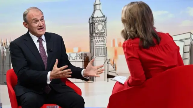 Ed Davey gestures as he speaks with Victoria Derbyshire