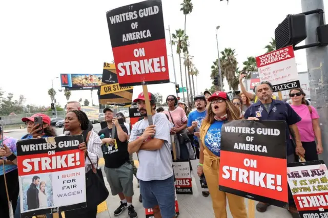 SAG-AFTRA actors and WGA writers walk the picket line during their ongoing strike outside Netflix offices in Los Angeles