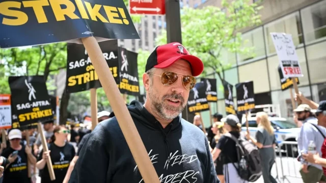 Actor Jason Sudeikis on a picket line, holding a strike sign