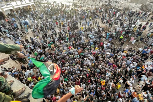 People gather for a demonstration outside the surviving Al-Sahaba mosque in Libya's eastern city of Derna on September 18, 2023, as they protest against government neglect to the two dams which broke and led to the deadly flash floods that hit the city the prior week.