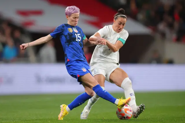 Lucy Bronze challenges Megan Rapinoe for the ball.