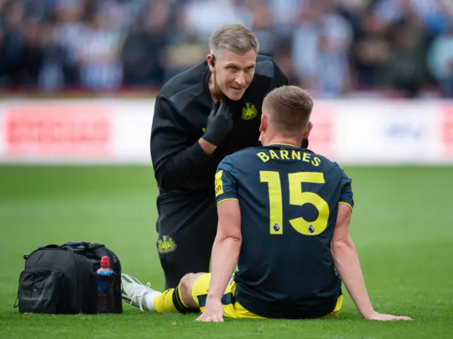 Harvey Barnes is checked by a Newcastle physio