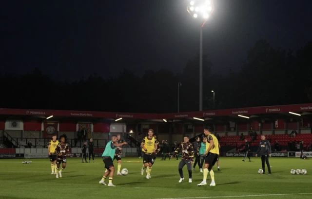 Burnley players warm-up at the Peninsula stadium