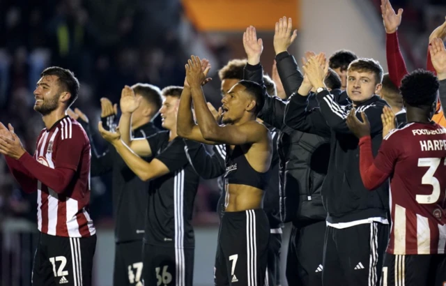 Exeter players applaud their fans