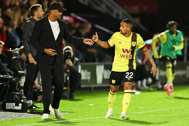 Vincent Kompany, Manager of Burnley, interacts with Vitinho of Burnley