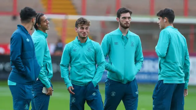 Luton players on the pitch at Exeter City