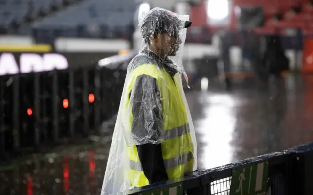 Member of staff in poncho