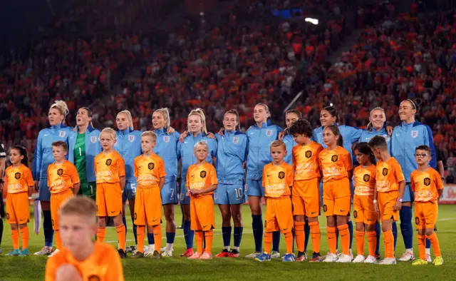 England players sing the national anthems with mascots stood in front of them.