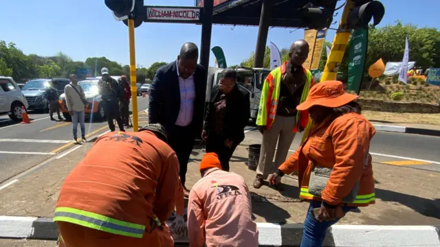 Road construction workers replace the sign of William Nicol Drive with the sign for Winnie Mandela Drive after the renaming of the road on 26 September.