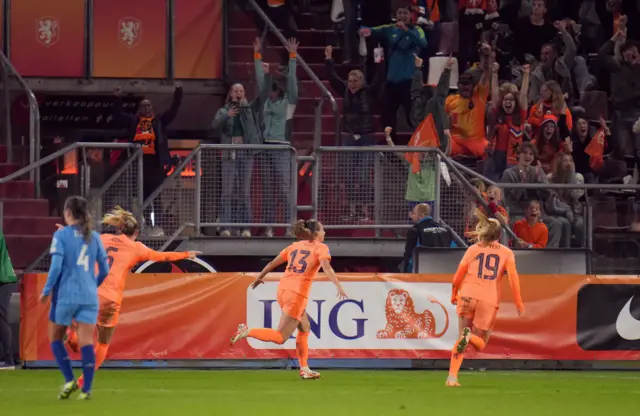 Renate Jasen runs off to celebrate with fans in the stadium.