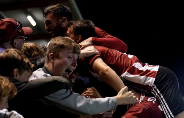 Exeter City players celebrate with the fans after Demetri Mitchell scores