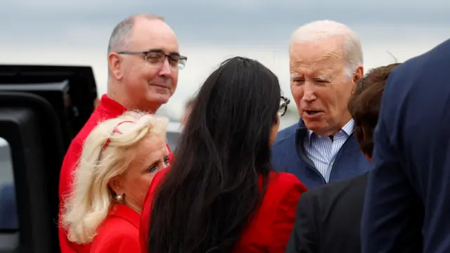 US President Joe Biden is greeted by Shawn Fain, President of the United Auto Workers (UAW), Rep. Shri Thanedar (MI-13), Lieutenant Governor Garlin Gilchrist, Rep. Debbie Dingell (MI-06) and Rep. Rashida Tlaib (MI-12) as he arrives at Detroit Metropolitan Wayne County Airport in Romulus,