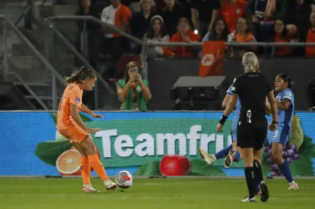 Lieke Martens shoots towards goal as Carter attempts to block.