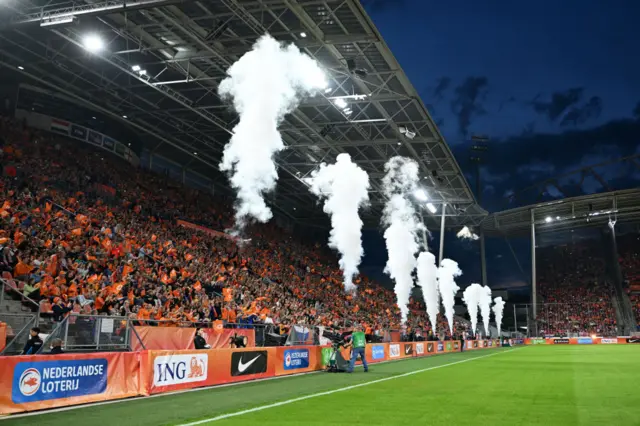 Smoke machines go off as the players walk out onto the pitch in Utrecht.