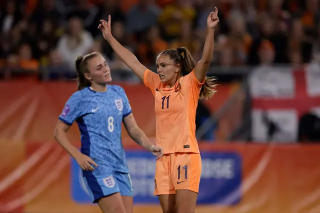 MArtens celebrates with her arms in the air, Stanway reacts to conceding.