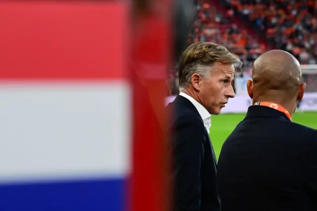 Joncker stands with assistant De Jong in front of the Dutch dugout.