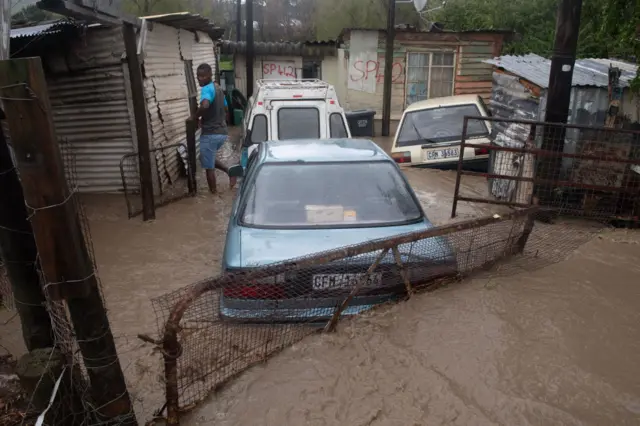 A view of cars covered with water and mud during heavy flooding as a result of a storm in Sir Lowry's Village, close Somerset West on September 25, 2023.