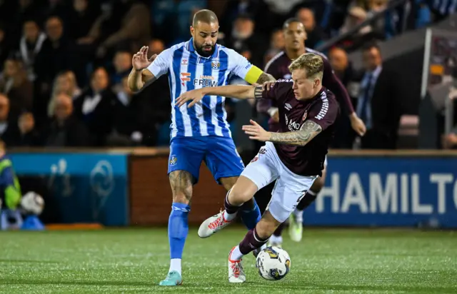 Kyle Vassell and Frankie Kent tussle for the ball