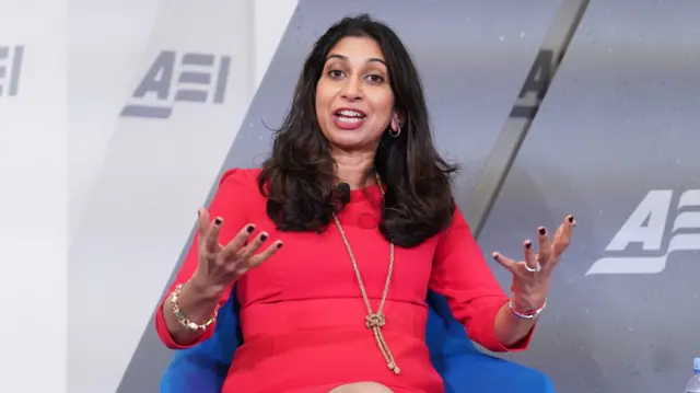 Braverman gestures as she gives a speech