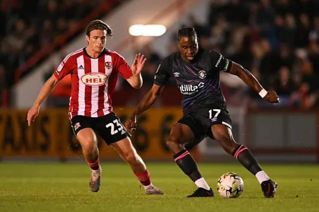 Kyle Taylor of Exeter City battles for possession