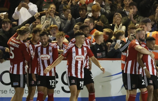 Exeter City players celebrate after their opener