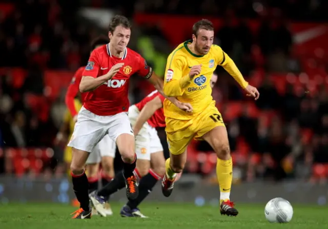 Glenn Murray of Crystal Palace competes with Jonny Evans