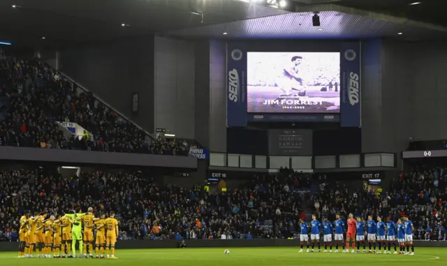 Livingston and Rangers players and fans conduct a minute's silence for the late Jim Forrest