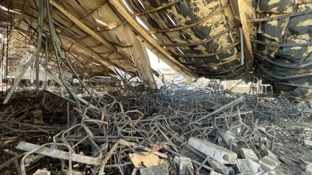 Charred furniture piled inside the venue