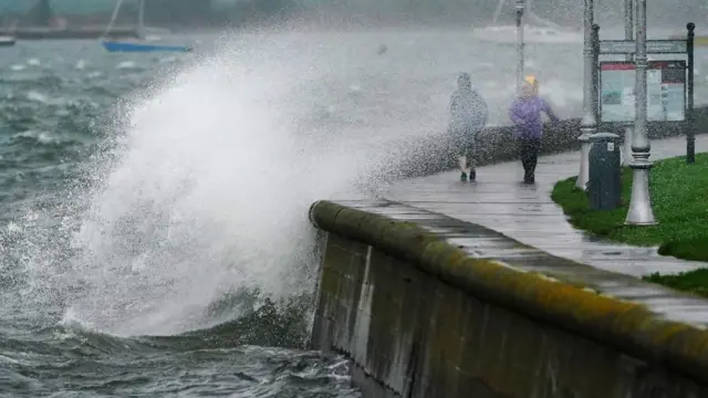 Spray catches people walk along the Clontarf promenade, Dublin