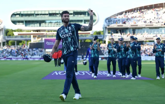 England's Reece Topley raises the match ball to the Lord's crowd after taking an England ODI record 6-24 against India