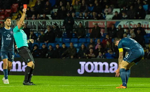 The referee brandishes a straight red