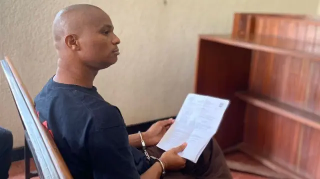 Denis Kazungu, 34, an alleged serial killer accused of killing more than 10 people in Rwanda, appears in a court on 21 September, 2023.