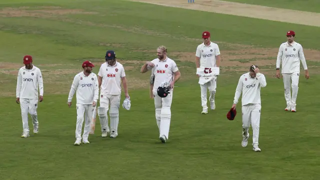 Essex and Northants players leave the field