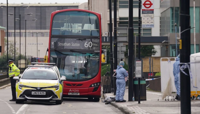 Police and forensic investigators at the scene near the Whitgift shopping centre in Croydon, south London after a 15-year-old girl was stabbed to death on Wednesday morning