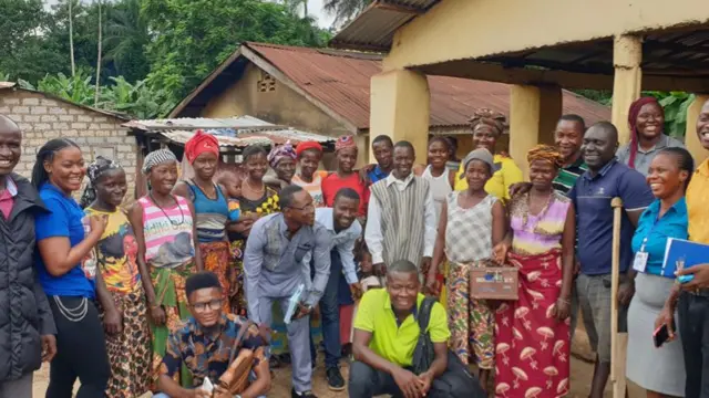 Residents of Port Loko with employees of non-profit Conforti, Sierra Leone