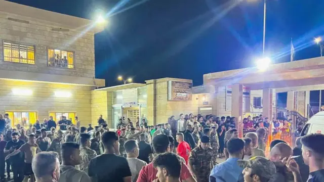 Crowd outside hospital after wedding hallf ire in Niniveh, Iraq