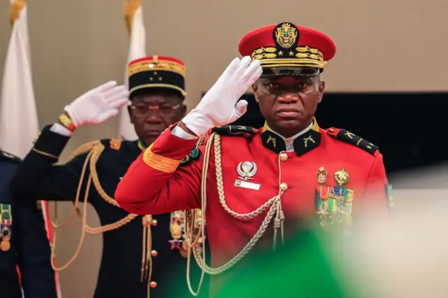 Gabon's new strongman General Brice Oligui Nguema (R) salutes as he is inaugurated as Gabon's interim President, in Libreville on September 4, 2023.