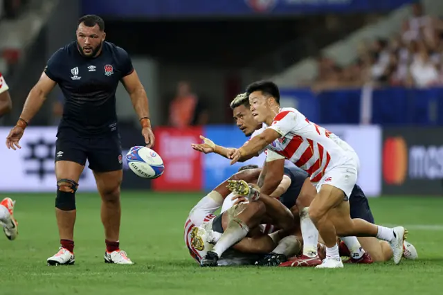 Naoto Saito of Japan passes the ball against England
