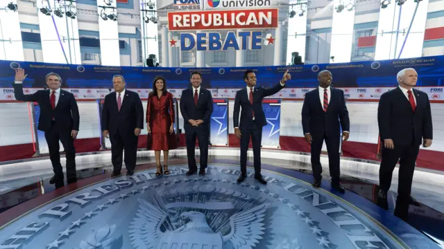 L-R) North Dakota governor Doug Burgum, former New Jersey governor Chris Christie, former South Carolina governor Nikki Haley, Florida governor Ron DeSantis, US entrepreneur Vivek Ramaswamy, South Carolina senator Tim Scott and former Vice President Mike Pence pose on stage prior to the GOP FOX Business Presidential Debate at the Ronald Reagan Presidential Library