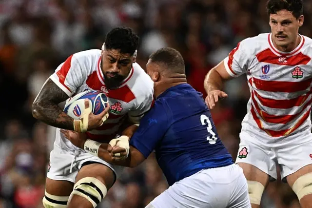 Japan's lock Amato Fakatava is tackled by Samoa's tighthead prop Paul Alo-Emile