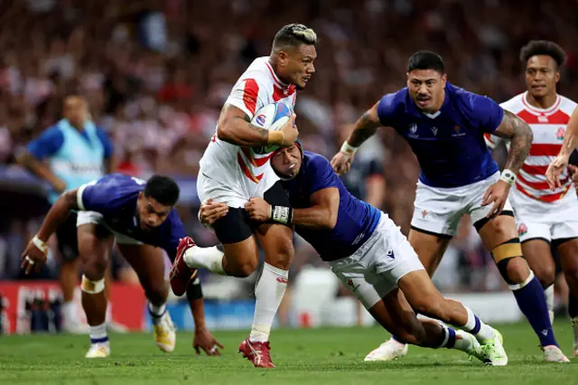 Lomano Lemeki of Japan is tackled by Christian Leali'ifano