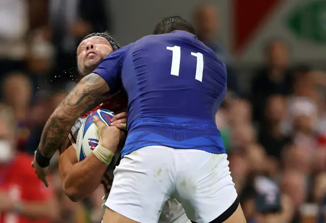 Pieter Labuschagne of Japan is hit by a high tackle from Ben Lam