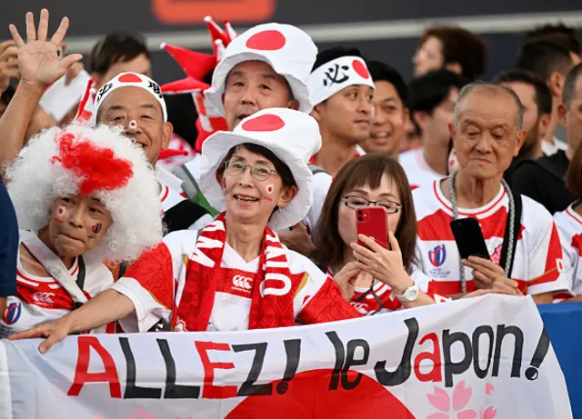 Fans of Japan pose for a photo as the players arrive