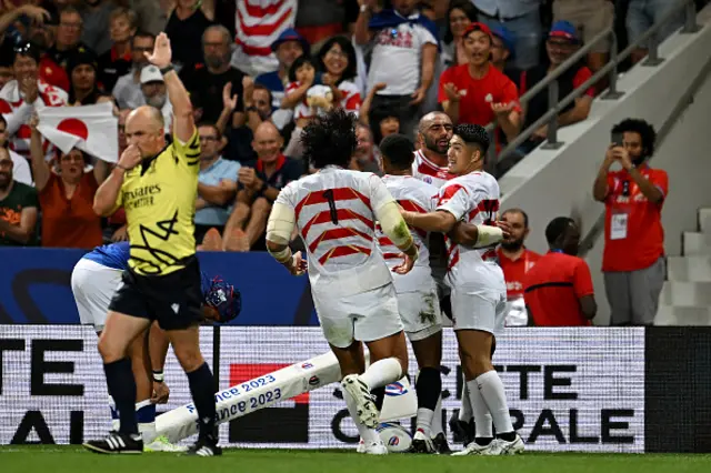 Michael Leitch of Japan celebrates with teammates