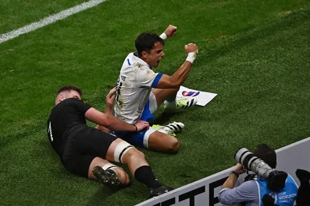 Italy's right wing Ange Capuozzo reacts after scoring a try