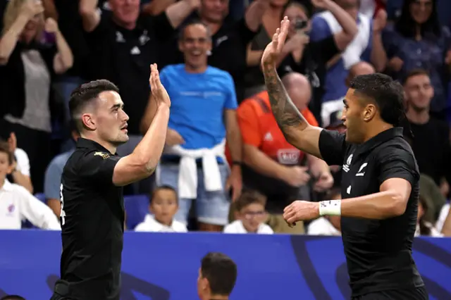 Will Jordan of New Zealand celebrates with Rieko Ioane