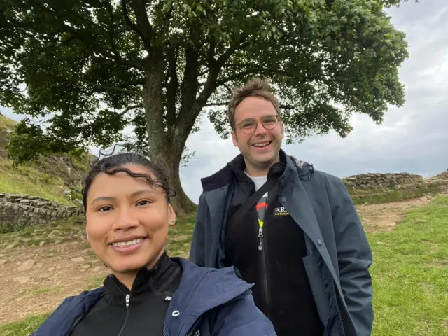 Diane's son and his girlfriend at the tree in July