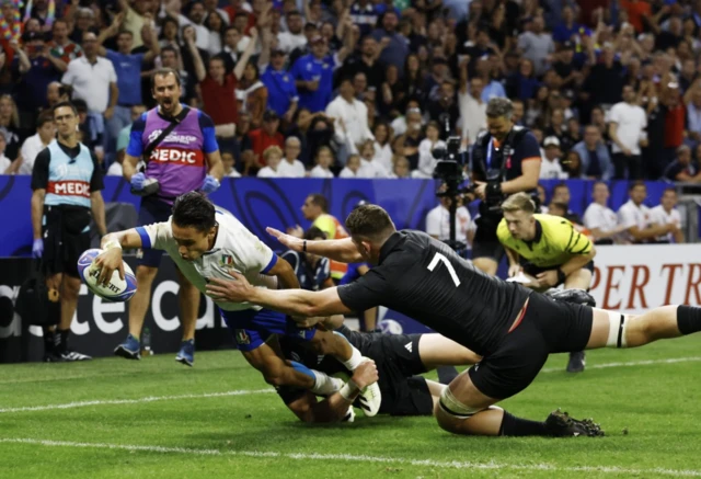 Italy's Ange Capuozzo scores their first try